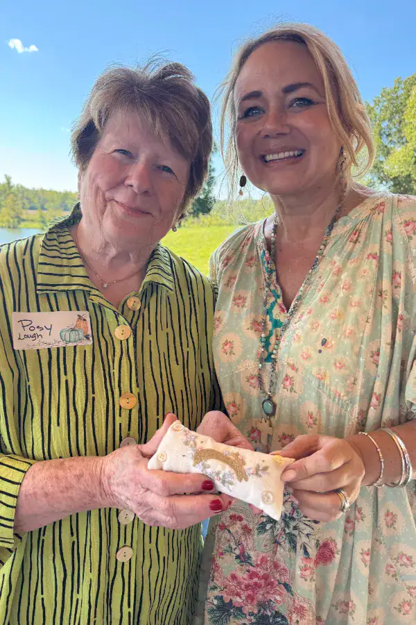 A picture of Posy Lowe and Niki Franklin holding a finished leaping rabbit pincushion