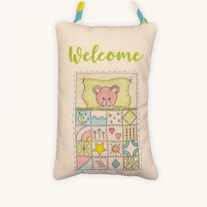 A completed nap time doorknob pillow embroidery kit by the Posy Collection