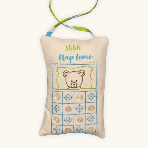 A completed nap time doorknob pillow embroidery kit by the Posy Collection