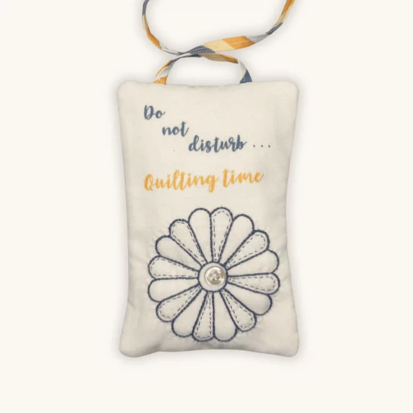 A completed Quilting Time Doorknob pillow by the Posy Collection