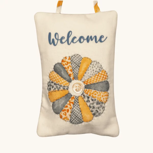 A completed Quilting Time Doorknob pillow by the Posy Collection