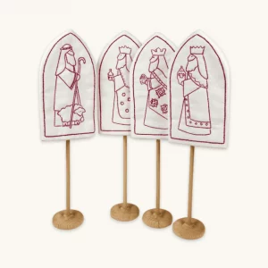 A completed 3 Kings and a Shepherd redwork embroidery project displayed in the included wooden stands.