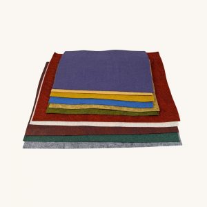 Wool felt pieces are folded and displayed on a table.