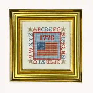 A completed 1776 Colonial Flag cross stitch kit by the Posy Collection displayed in a frame.